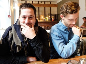 Portrait of two men sitting in cafe