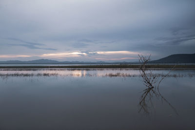 Scenic view of lake against sky during sunset