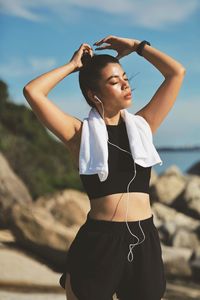 Young woman standing at beach