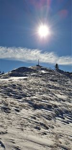 Scenic view of snow covered land against sky