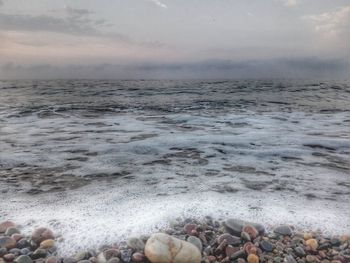 Scenic view of sea against cloudy sky