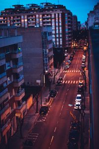 High angle view of city street and buildings at night