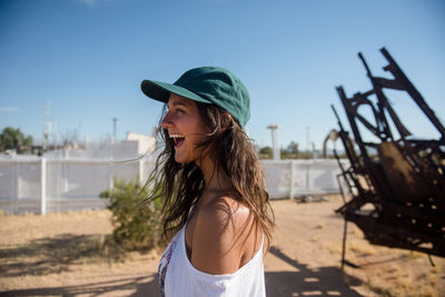 An adventurou woman smiles while exploring the desert