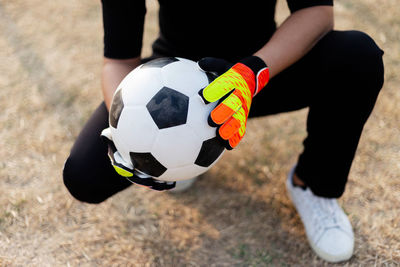 Low section of person playing soccer ball