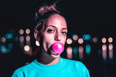 Portrait of young woman at night