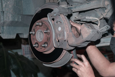 Cropped hand of man repairing car