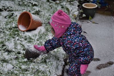 Cute girl playing in snow outdoors