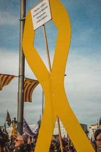 Low angle view of information sign against sky