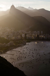 High angle view of townscape by sea against sky