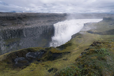Biggest waterfall in europe, dettifoss. muddy waters falling over the edge. 
