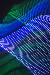 Close-up of multi colored light painting against black background