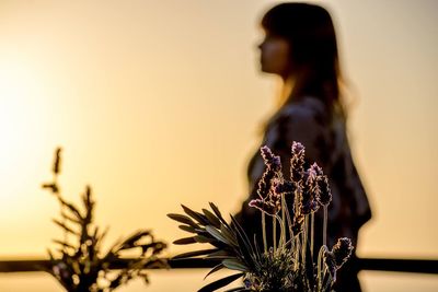 Woman looking away at sunset