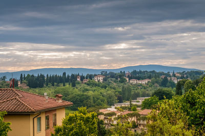 Houses and trees against sky