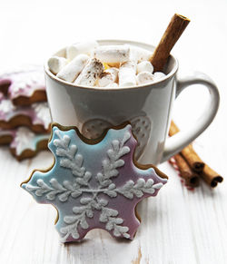 Christmas cocoa, gingerbread cookies and decorations. white wooden background.