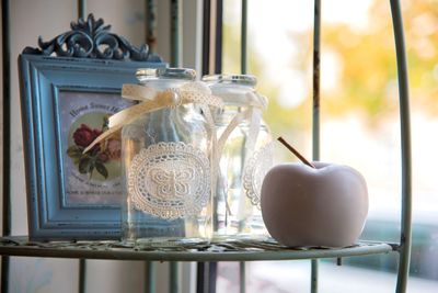 Close-up of apples in glass jar on table