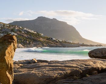 Scenic view of sea and mountains against sky