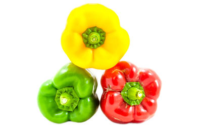 Close-up of multi colored bell peppers against white background