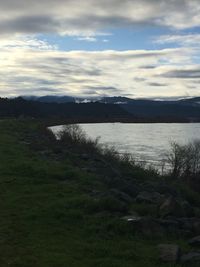 Scenic view of lake against cloudy sky