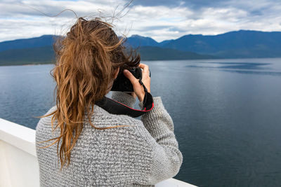 Rear view of woman looking at sea