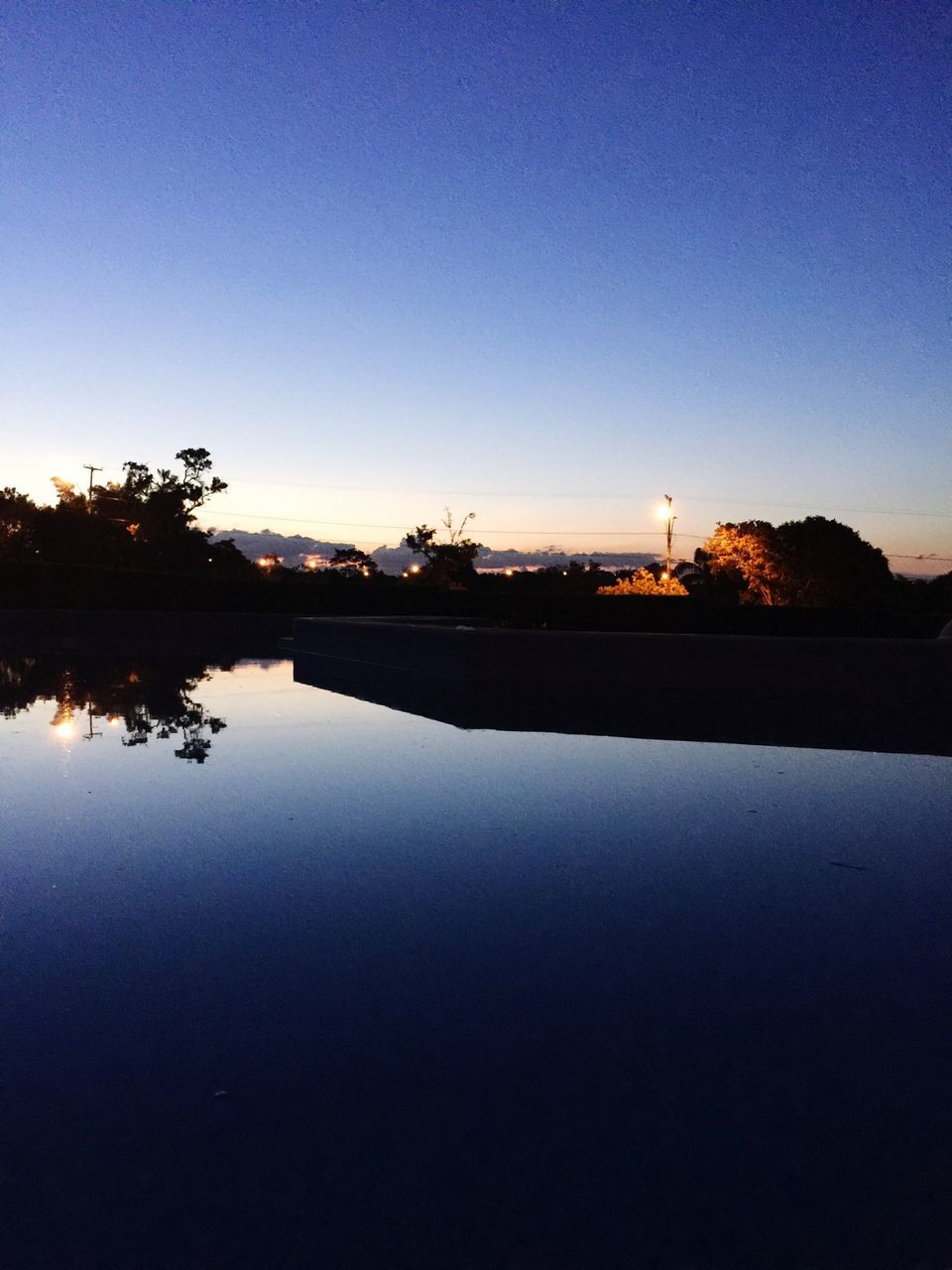 reflection, water, sunset, sky, tranquility, nature, beauty in nature, tree, scenics, idyllic, outdoors, no people, tranquil scene, clear sky, refraction, astronomy, day