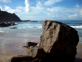 Close-up of beach against sky