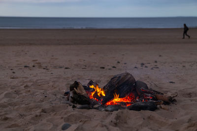 Bonfire on beach against sky