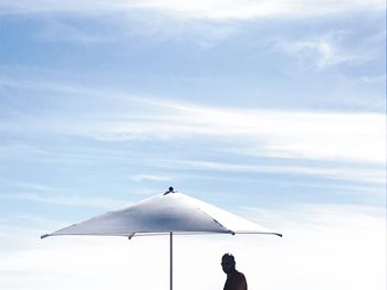 Rear view of person standing against sky