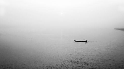 Silhouette ship in sea against sky