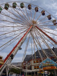 Low angle view of ferris wheel against sky