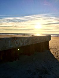 Scenic view of beach against sky during sunset