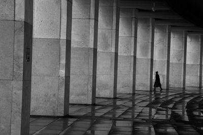 Full length of man walking against built structure