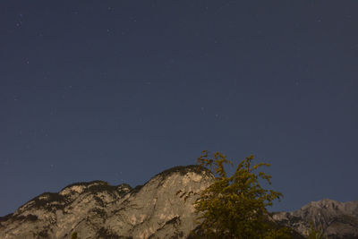 Low angle view of mountain against sky at night