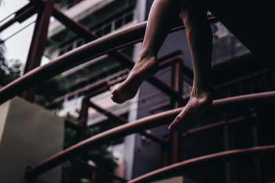 Low section of person on railing