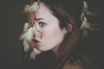 Close-up beautiful young woman wearing dreamcatcher at night