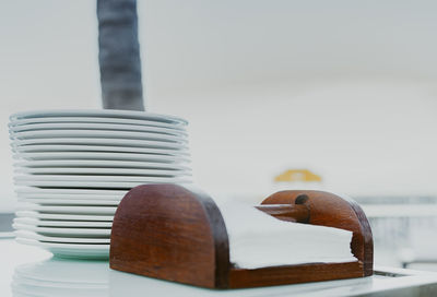 Close-up of stack of plates and napkins on table