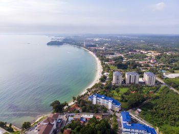 High angle view of buildings by sea against sky