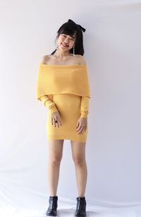 Portrait of a smiling young woman against white background
