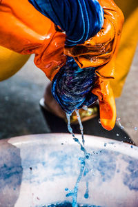 Close-up of man pouring water