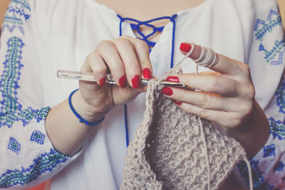 Midsection of woman knitting wool