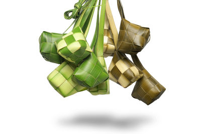 High angle view of bottles on table against white background