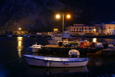 Boats in harbor at night