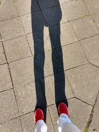 Low section of man standing on footpath