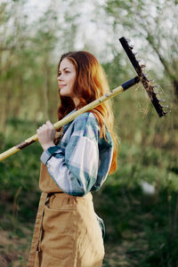 Smiling woman holding farmer rack