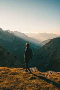 Man standing on mountain against sky