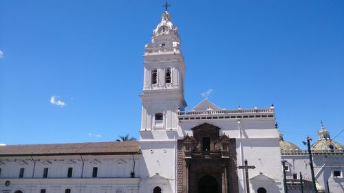 Low angle view of bell tower against blue sky