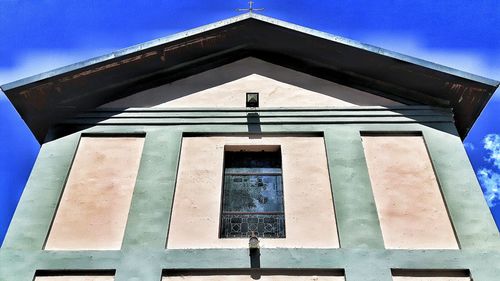 Low angle view of built structure against blue sky