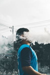 Rear view of man standing against sky