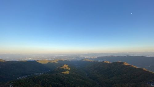 Scenic view of mountains against clear blue sky