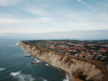 High angle view of sea and buildings against sky