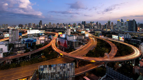 High angle view of illuminated city against sky